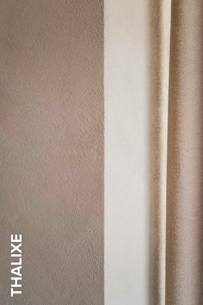 muur met Thalostuc Thalixe structuur naast beige gordijn